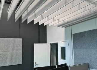 Acoustic Baffle Raft & Acoustic V-Grooved wall Panels in an open office.