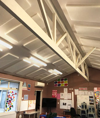 White Polyester 
acoustic ceiling panels at Birchwood Intermmediate School.