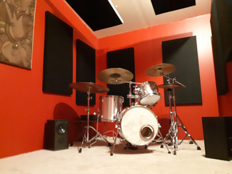 Acoustic wall panels and suspended sound cloud panels in new drum 
room.
