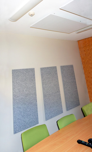Designer grey marl wall acoustic 
panels and suspended white Designer ceiling acoustic panels in meeting room.