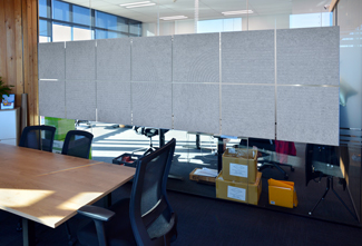 Acoustic V-Grooved wall Panels on a glass Meeting Room wall.
