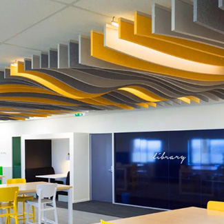 Yellow and grey acoustic Ceiling baffles direct fixed in a school classroom.